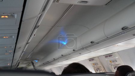 Photo for Passengers traveling by plane, shot from the inside of an airplane. Interior of a commercial airplane. - Royalty Free Image