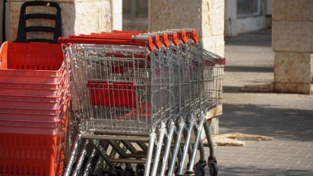 Photo for Row of Empty shopping trolleys and baskets near supermarket - Royalty Free Image