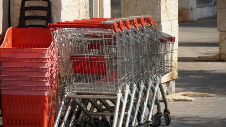 Photo for Row of Empty shopping trolleys and baskets near supermarket - Royalty Free Image