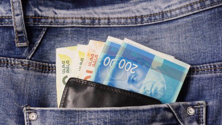 Photo for Money in the pocket of jeans. Colorful Israeli shekel in a ieather wallet - Royalty Free Image