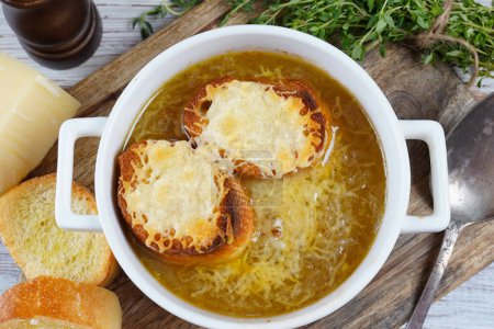 A classic French Onion Soup with with gruyere cheese and toasted baguette in a bowl-stock-photo