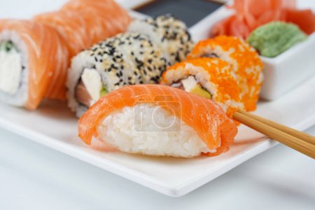 Photo for Japanese traditional Cuisine - Set of Nigiri sushi and sushi rolls - Royalty Free Image