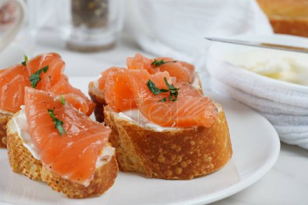 Open sandwiches with salmon fillet, wheat bread with butter and herbs