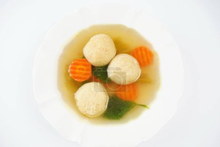 Jewish chicken broth with kneidlach (balls made with matzo meal). Matzo ball soup