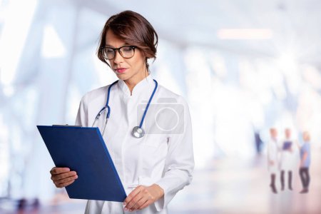 Photo for Thinking female doctor holding clipboard - Royalty Free Image