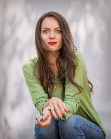 Photo for Portrait of beautiful smiling young woman. Attractive young female having green eyes and long brunette hair. Red lipstick. Copy space - Royalty Free Image
