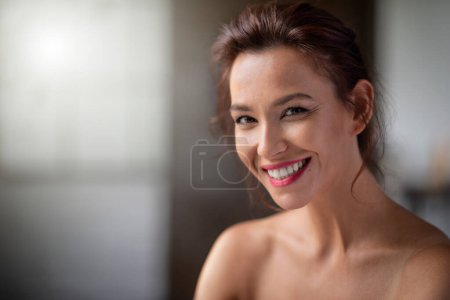 Photo for Headshot of a brunette haired mid aged woman cheerful smiling and looking at camera inside. - Royalty Free Image