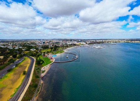 Photo for Aerial views from Port Phillip Bay towards Geelong CBD and Eastern Beach Childrens Pool on a warm summer morning in Geelong, Victoria, Australia - Royalty Free Image