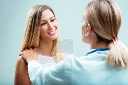 A blonde doctor deeply cares for her patient. Beyond physical health, she values human connection, trust and emotional well-being