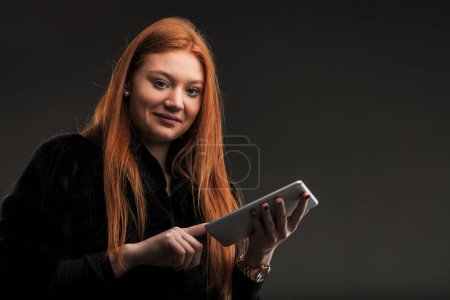 Professional with a keen eye for digital trends explores market analytics on her tablet