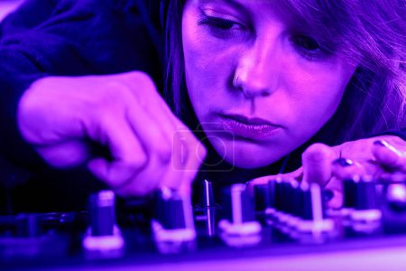 Absorbed in her craft, a DJ's commitment to sound resonates in the ultraviolet spotlight