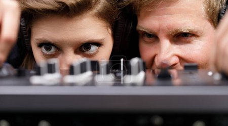 close-up of DJs in action, with their eyes locked on the mixer, illustrates a deep connection to their craft