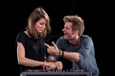 The male DJ's enthusiasm is infectious, drawing a smile from the female DJ during their set