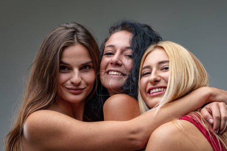 Blonde, brunette, and black-haired friends exude happiness together
