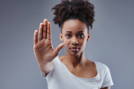 Expressing control with an open palm, she embodies empowerment and the assertive declaration of limits