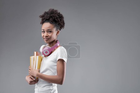The determined student, with her study materials, embodies commitment to her scholarly journey and aspirations