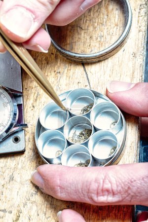 Focused precision at the bench: a watchmaker's steady hand aligns the delicate gears of time