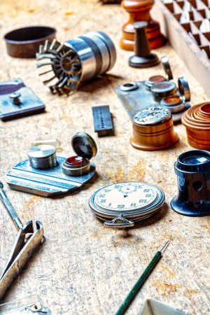 Amidst horology's chaos, a dismembered watch case lies, the silent heart of time paused