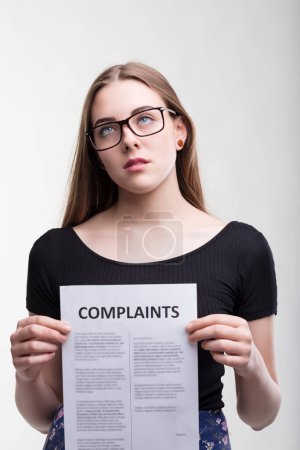 Bored professional stares at complaints, exasperation from problems palpable