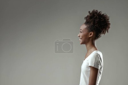 young woman's face radiates happiness as she reacts to a delightful moment, her joy unmistakable