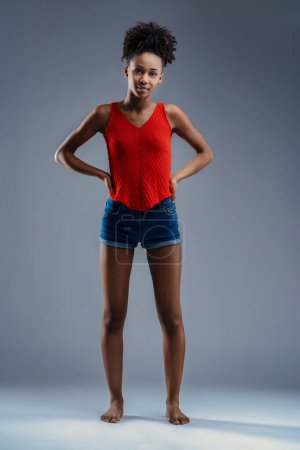Confident stance from a young woman of color in striking summer attire