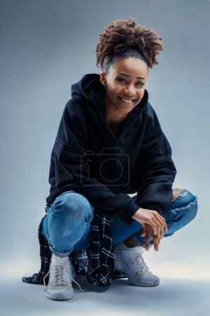 Mischievous gaze of a woman in a casual, comfortable hoodie