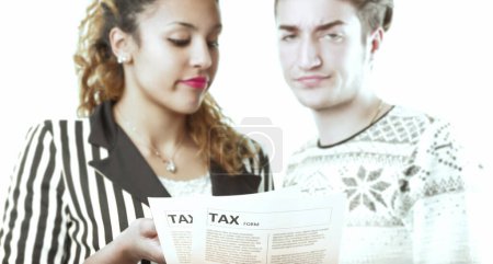 couple faces the inconvenience of tax paperwork, their expressions showing irritation and concern over the tedious process