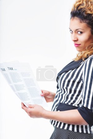 Confident woman holding tax forms, her expression revealing a clever solution she has just thought of to simplify the task