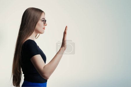 Woman's raised hand might imply greeting, stopping action, or initiating a friendly high-five