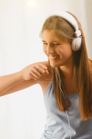 Radiating happiness, the young dancer moves to the beat, her headphones linking her to a world of sounds