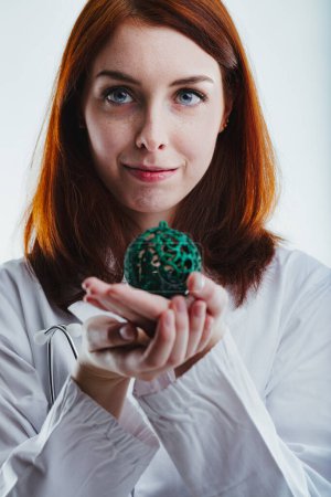 red-haired woman in a white lab coat, holding a green ornamental ball, symbolizes the importance of healthcare and medical research during charitable Christmas donations