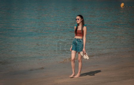 tourist woman walking on the beach