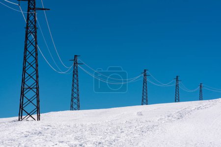 Photo for Row of electric pile with wires in winter - Royalty Free Image