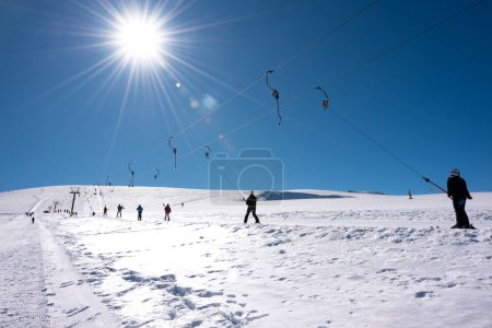 Photo for People using ski lift on sunny winter day on a i resort - Royalty Free Image