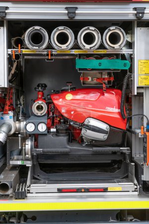 Photo for Templin, Brandenburg - Germany - 06-09-2022: A detailed view of firefighting gear stored neatly in a fire engine's compartment, ready for rapid deployment - Royalty Free Image