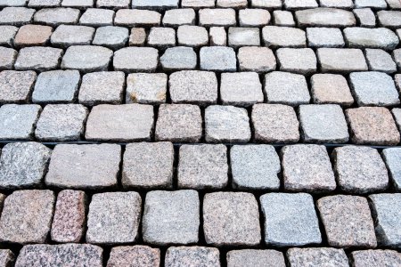 Close-up of a perfectly laid cobblestone pavement, showcasing symmetry and urban design