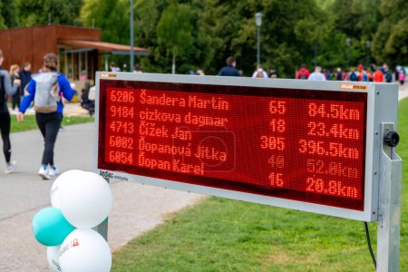 Photo for Prague, Capital City of Prague - Czech Republic - 09-18-2022: Electronic scoreboard showing runners' names and distances at a Prague event - Royalty Free Image