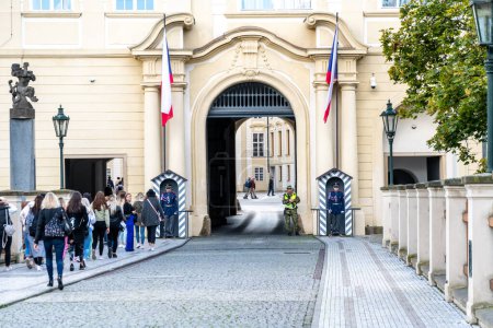 Photo for Prague, Capital City of Prague - Czech Republic - 09-22-2022: Uniformed guards on duty at an ornate arched gateway in Prague, Czech Republic - Royalty Free Image