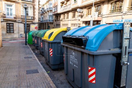 Photo for Cartagena, Murcia - Spain - 01-16-2024: A row of color-coded recycling containers on a Cartagena street - Royalty Free Image