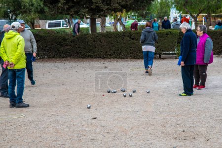 Photo for La Manga, Murcia - Spain - 01-09-2024: People of various ages playing boule on a sandy pitch at a Spanish campsite - Royalty Free Image