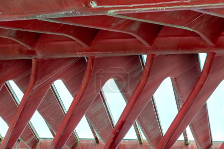 Venice, Veneto - Italy - 06-10-2021: Underside view of Venice Constitution Bridge, showing details of red steel truss design