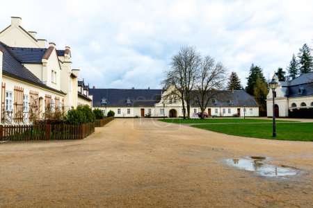 Photo for Bad Muskau, Saxony - Germany - 04-18-2021: Expansive courtyard of Bad Muskau featuring manor houses and lush greenery, called Bauhof - Royalty Free Image