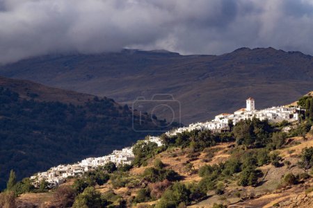Photo for View of the white village of Capileira in the Alpujarra Region with the Sierra Nevada mountains in the backgroud. Granada, Andalucia, Spain - Royalty Free Image