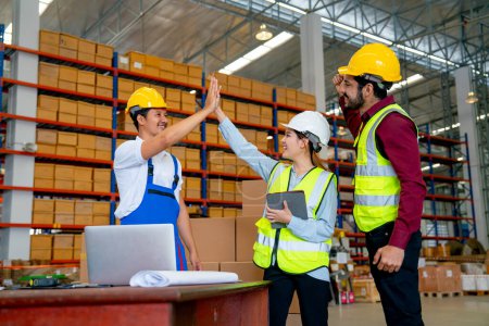 Photo for Warehouse manager woman clap hands with her co-worker to express successful of the project and also cheer up with the member in workplace. - Royalty Free Image