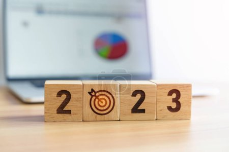 Photo for 2023 Year block with dartboard icon against computer laptop background. Goal, Target, Resolution, strategy, plan, Action, mission, motivation, and New Year start concepts - Royalty Free Image