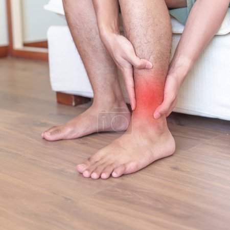 Man having leg pain due to Ankle Sprains or Achilles Tendonitis and Shin Splints ache. injuries, health and medical concept