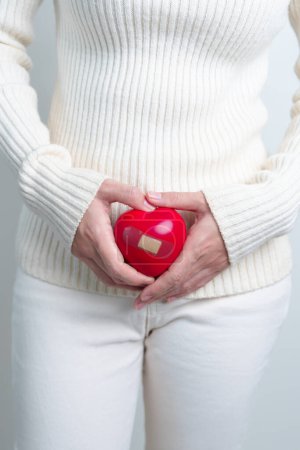 Photo for Woman holding  red heart shape. Pregnancy, Reproductive system, menstruation, and gynecology concept - Royalty Free Image