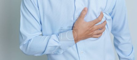 Foto de Man hand holding chest ache. Heart disease, angina disease and symptom heart attack disease Cardiovascular, Atherosclerosis, Hypertensive world Heart day and health concept - Imagen libre de derechos