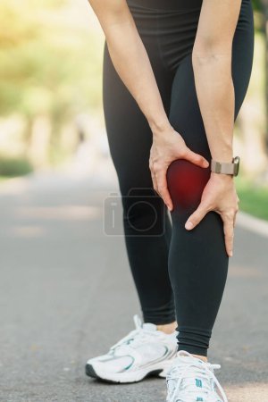 Photo for Adult woman with muscle pain during running. runner have knee ache due to Runners Knee or Patellofemoral Pain Syndrome, osteoarthritis and Patellar Tendinitis. Sports injuries and medical concept - Royalty Free Image