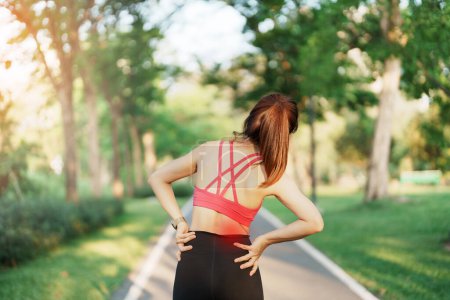 Photo for Adult female with her muscle pain during running. runner woman having back and Waist body ache due to Piriformis Syndrome, Low Back Pain and Spinal Compression. Sports injuries and medical concept - Royalty Free Image